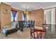Elegant dining room with a glass table, chandelier, and an adjacent living room at 2405 W Serene Ave # 817, Las Vegas, NV 89123