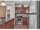 Well-equipped kitchen featuring granite counters, stainless steel appliances, and ample dark wood cabinetry at 2405 W Serene Ave # 817, Las Vegas, NV 89123