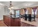 Open concept living and dining area featuring modern decor, bright windows, and dark wood furnishings at 2405 W Serene Ave # 817, Las Vegas, NV 89123