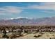 Community homes overlook snow-capped mountains against a bright blue sky at 2405 W Serene Ave # 817, Las Vegas, NV 89123