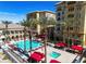 Beautiful community pool area featuring palm trees, lounge chairs, and stylish cabanas at 2405 W Serene Ave # 817, Las Vegas, NV 89123