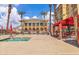 Outdoor pool featuring lounge chairs, umbrellas, and a covered seating area with a two-story building in the background at 2405 W Serene Ave # 817, Las Vegas, NV 89123