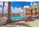 Inviting outdoor pool area with lounge chairs and a view of the building under a partly cloudy sky at 2405 W Serene Ave # 817, Las Vegas, NV 89123