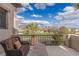 Balcony view showcases golf course and desert landscape under a blue sky with clouds at 2436 Grassy Spring Pl, Las Vegas, NV 89135