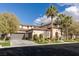 Beautiful home featuring lush landscaping, tall palm trees, and a well-manicured lawn enhancing curb appeal at 2436 Grassy Spring Pl, Las Vegas, NV 89135