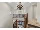 Grand foyer with curved staircase features elegant wrought iron railings and a decorative chandelier at 2436 Grassy Spring Pl, Las Vegas, NV 89135