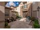 Home exterior featuring stone accents, an arched entrance, courtyard and tastefully landscaped grounds at 2436 Grassy Spring Pl, Las Vegas, NV 89135