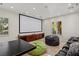 Entertainment room with movie screen, comfortable seating, and game tables for leisure and relaxation at 2436 Grassy Spring Pl, Las Vegas, NV 89135