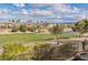Picturesque view of lush golf course, mature trees, and elegant homes under a partly cloudy sky at 2436 Grassy Spring Pl, Las Vegas, NV 89135