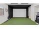 An indoor golf simulator with a projector screen at 2436 Grassy Spring Pl, Las Vegas, NV 89135