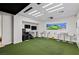 This indoor golf simulator features a Trackman system and artificial turf at 2436 Grassy Spring Pl, Las Vegas, NV 89135
