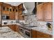 Up-close view of the gourmet kitchen's countertops, Wolf oven, and custom wood cabinets at 2436 Grassy Spring Pl, Las Vegas, NV 89135