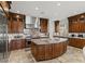 Gourmet kitchen with stainless appliances, island, granite countertops, and custom cabinets at 2436 Grassy Spring Pl, Las Vegas, NV 89135