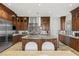 Gourmet kitchen featuring stainless steel appliances, custom cabinetry, and granite countertops at 2436 Grassy Spring Pl, Las Vegas, NV 89135