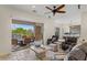 Open living room with leather furniture and access to outdoor waterfall pool area at 2436 Grassy Spring Pl, Las Vegas, NV 89135