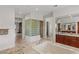 Luxurious main bathroom featuring a large soaking tub, a glass block partition and stone floors at 2436 Grassy Spring Pl, Las Vegas, NV 89135
