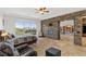 Spacious bedroom featuring stone accent wall, fireplace, and access to a private balcony with golf course views at 2436 Grassy Spring Pl, Las Vegas, NV 89135