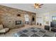 Bright bedroom featuring a stone accent wall with fireplace and an adjoining sitting area at 2436 Grassy Spring Pl, Las Vegas, NV 89135