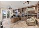 Well-lit office featuring custom built-in shelving, a large desk, and access to an outdoor patio at 2436 Grassy Spring Pl, Las Vegas, NV 89135