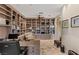 Office with a large desk and custom wall-to-wall shelving, and a comfortable armchair at 2436 Grassy Spring Pl, Las Vegas, NV 89135