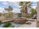 Relaxing spa and pool area with stone accents and palm trees, offering a private outdoor oasis at 2436 Grassy Spring Pl, Las Vegas, NV 89135