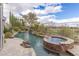 Backyard pool and jacuzzi with waterfall feature surrounded by desert landscaping at 2436 Grassy Spring Pl, Las Vegas, NV 89135