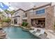 Beautiful outdoor pool with lounge chairs, water features, and a patio area, perfect for relaxing and entertaining at 2436 Grassy Spring Pl, Las Vegas, NV 89135