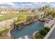 Aerial view of the pool featuring a waterfall, hot tub, and desert landscaping at 2436 Grassy Spring Pl, Las Vegas, NV 89135