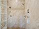 Walk-in shower featuring dual shower heads, designer tile, and a glass block partition at 2436 Grassy Spring Pl, Las Vegas, NV 89135