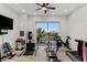 A home workout room with multiple machines has access to a terrace overlooking the landscape at 2436 Grassy Spring Pl, Las Vegas, NV 89135