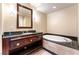 Elegant bathroom featuring a deep soaking tub, dark wood vanity, and stylish lighting at 2700 Las Vegas Blvd # 910, Las Vegas, NV 89109