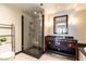 Contemporary bathroom with a glass-enclosed shower, dark wood vanity, and sleek fixtures at 2700 Las Vegas Blvd # 910, Las Vegas, NV 89109