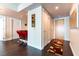 Hallway leading to a modern kitchen and bar area with a geometric rug on hardwood floors at 2700 Las Vegas Blvd # 910, Las Vegas, NV 89109
