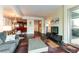 Open living room with modern furniture, hardwood floors, balcony with a view and bar seating at 2700 Las Vegas Blvd # 910, Las Vegas, NV 89109
