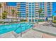 Exterior view of a pool with tall condominiums in the background, palm trees and lounge chairs at 2700 Las Vegas Blvd # 910, Las Vegas, NV 89109