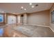 Bright and spacious living room with hardwood floors, plush carpeting, and ample natural light; neutral color palette at 2784 Cherrydale Falls Dr, Henderson, NV 89052