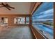 Open living room with hardwood floors and large windows overlooking a private swimming pool at 2784 Cherrydale Falls Dr, Henderson, NV 89052