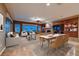 Bright, open living room with dining area, large windows, and built-in wooden cabinets at 2784 Cherrydale Falls Dr, Henderson, NV 89052