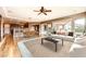 Living room and kitchen combo featuring hardwood floors, kitchen island, and modern design at 2784 Cherrydale Falls Dr, Henderson, NV 89052