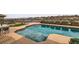 Relaxing outdoor pool boasts desert views beyond the rod iron fence and colorful floral accents at 2784 Cherrydale Falls Dr, Henderson, NV 89052