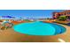 Large outdoor community pool with lounge chairs and umbrellas at 2784 Cherrydale Falls Dr, Henderson, NV 89052