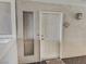 Neutral-colored front door with sidelight window and welcome mat at 2867 Geary Pl # 3008, Las Vegas, NV 89109
