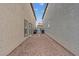 Narrow backyard space between two homes featuring gravel landscaping and a gated entrance at 2945 Torreon Ln, Las Vegas, NV 89121