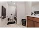 Bright bathroom featuring a vanity, toilet, and shower with neutral tile at 2945 Torreon Ln, Las Vegas, NV 89121