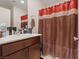 Bathroom featuring a vanity with a modern sink and a shower with dark accents at 2945 Torreon Ln, Las Vegas, NV 89121