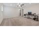 A spacious bonus room with a ceiling fan, neutral carpet, and a black desk at 2945 Torreon Ln, Las Vegas, NV 89121