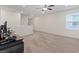 Spacious bonus room with a large window, ceiling fan, and neutral carpet at 2945 Torreon Ln, Las Vegas, NV 89121