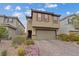 Two-story home featuring a two-car garage, neutral color palette, and well-maintained front yard at 2945 Torreon Ln, Las Vegas, NV 89121