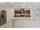 Kitchen featuring granite countertops, stainless steel appliances, and sleek dark wood cabinets at 2945 Torreon Ln, Las Vegas, NV 89121