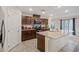 Bright kitchen boasts tile floors, granite counters, and dark wood cabinets at 2945 Torreon Ln, Las Vegas, NV 89121